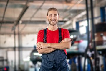 Fototapeta premium Smiling man in uniform posing in garage