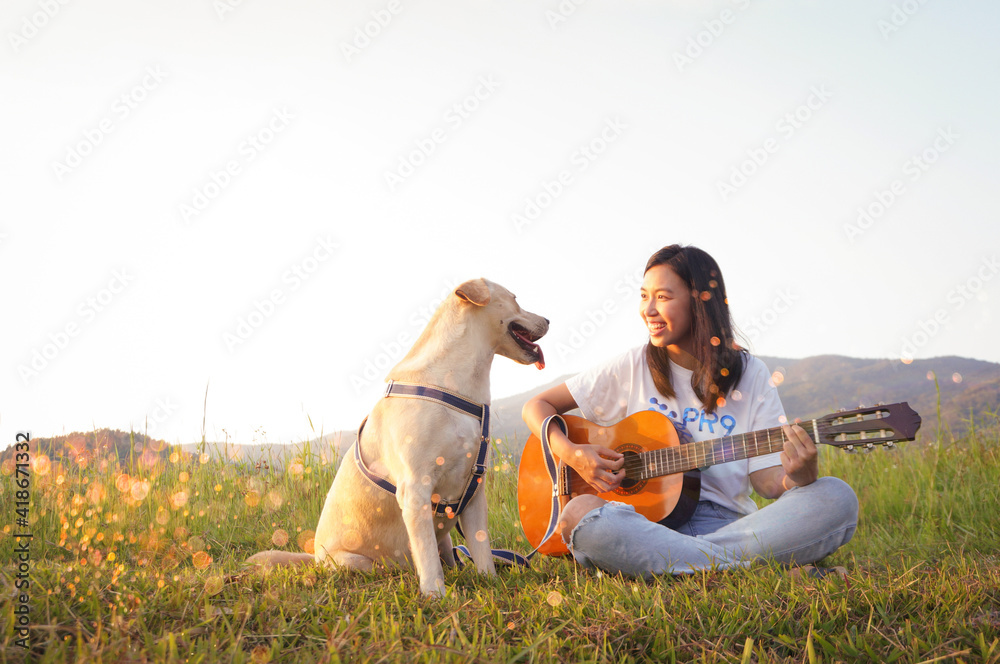 Wall mural activity of cute dog and girl play guitar at park with copy space in summer