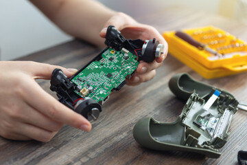 Close up of disassemble game controller repairing, cleaning or diagnostic. - obrazy, fototapety, plakaty