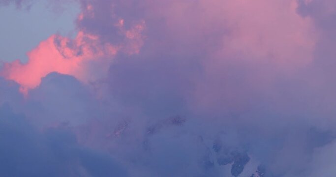 Lockdown shot of Aiguille du Midi mountain peak amidst clouds at sunset - Chamonix, France