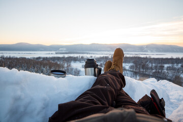 person watching the sunset on snow mountaion
