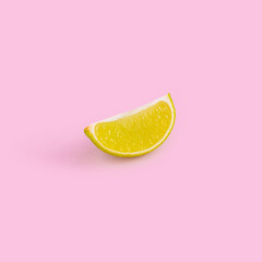 Single slice of lime on pastel pink background