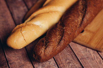 slicing fresh bread on a wooden cutting board breakfast meal