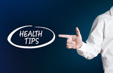 Male hand points to the word heath tips with an outline circle on blue background.
