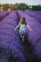 girl running across the field with lavender