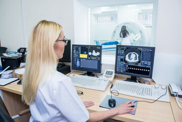 Radiologist in the control room of computed tomography at hospital