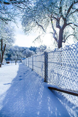 eingeschneiter Zaun ganz weis im Winter mit viel Schnee und Eis