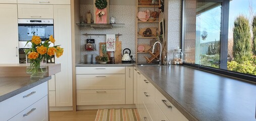 Wooden top on background of modern kitchen with window and shelves.