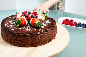 Homemade cheesecake with dark chocolate and strawberries