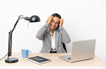 Naklejka premium Young business mixed race woman working at office laughing