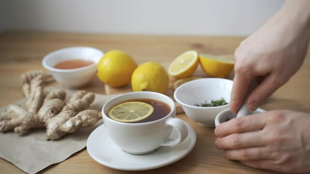 Cup of healthy tea with different kind of dryed herbs and flowers