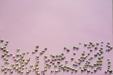 rhinestones on a pink background, top photo. design for text
