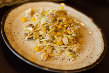 warm salad with chicken, cabbage and with corn and mustard sauce