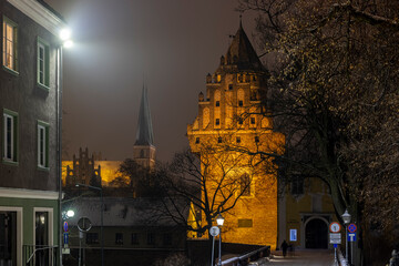 Obraz premium Olsztyn castle at night - the Castle of the Warmian Chapter in Olsztyn. Museum of Warmia and Mazury and the garrison church of Our Lady Queen of Poland in Olsztyn