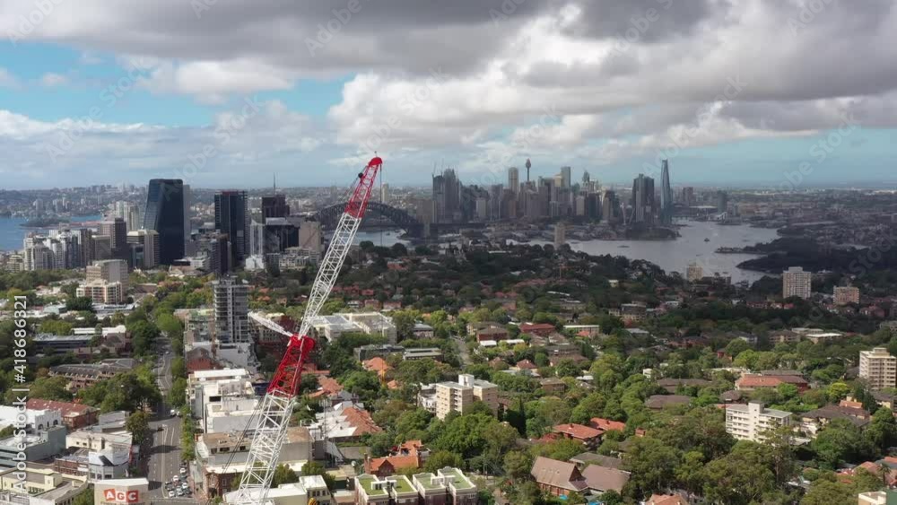 Sticker constuction crane in view of sydney city cbd high-rise towers – aerial 4k.