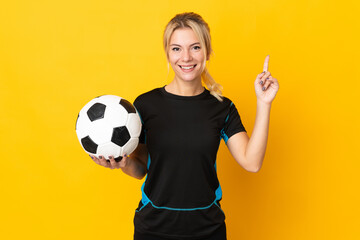 Young Russian football player woman isolated on yellow background pointing up a great idea