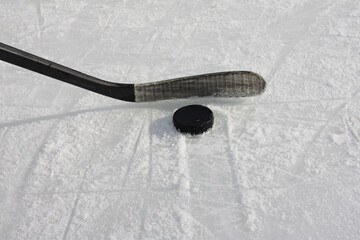 Hockey Stick and Puck on Ice Rink