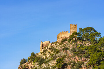 Fototapeta na wymiar Ruined castle at the top of a mountain. Castell de Serra, (Serra's Castle) Valencia, Spain.