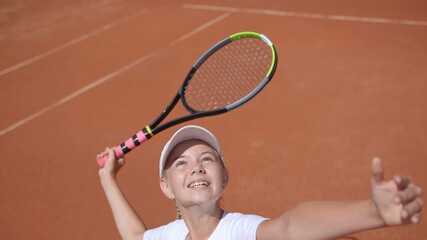 A young tennis player serves in the game. - obrazy, fototapety, plakaty