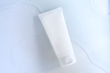 white cosmetic tube with face cream, hand cleanser or body lotion . The concept of a moisturizing product for skin care