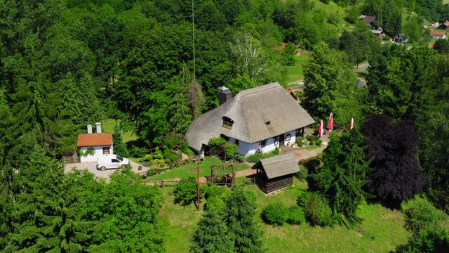 Traditional rural house with a thatched roof in Podravina region of Croatia 