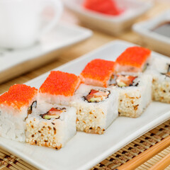 Non-classic california roll with salmon and flying fish roe
