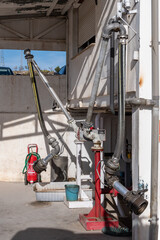 Specific arms for fuel loading in a diesel storage plant for heating and agricultural uses.