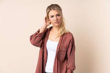 Blonde woman over isolated background having doubts