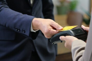 Businessman using credit card for purchase and payment something service by electronic machine internet banking reader