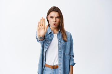 No, stop right there. Serious woman making block, stretch out hand to prohibit action, disapprove...