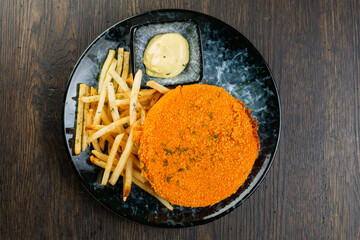 deep-fried breaded cheese with French fries and gritsy sauce. view from above