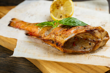 whole baked fish in foil with lemon. fried bass