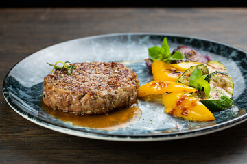 grilled minced beef cutlet with grilled vegetables and barbecue sauce. fried zucchini, onion and...