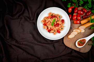 Top view macaroni pasta with tomato sauce, pork and vegetables.