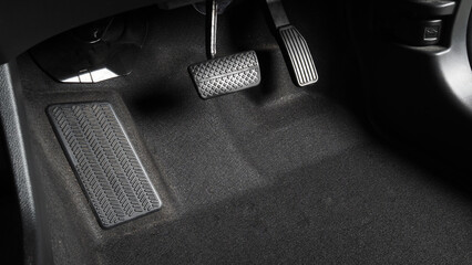Accelerator and breaking pedal in a car. Close up the foot pressing foot pedal of a car to drive...