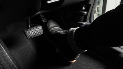Accelerator and breaking pedal in a car. Close up the foot pressing foot pedal of a car to drive...