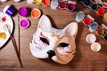 A cat mask design making by teenage girl. Drawing, creativity, hobby, diy, painting, development, education concept. Do it yourself step by step process.