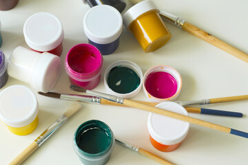 top view of painting tool, gouaches and painting brushes
