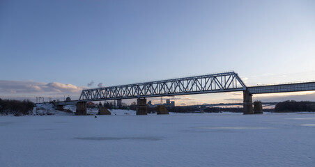 railway bridge winter. Railway bridge over the river. Steel structure, railway.