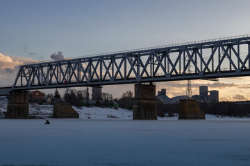 Fototapeta premium railway bridge winter. Railway bridge over the river. Steel structure, railway.