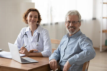 Obraz premium Portrait of happy elderly Caucasian male patient feel satisfied with good quality service in clinic. Smiling mature man excited with consultation with female doctor in hospital. Geriatric concept.