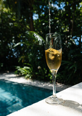 Tropical cocktail on a background of tropical plant leaves and sun shades. on a background of tropical plant. Color background