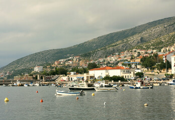 Fototapeta na wymiar Port of Senj, Croatia. View of the port on the Adriatic Sea in Senj. Moored boats. In the background, the mountain above the town of Senj 