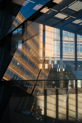 Office building reflected in glass facade. Abstract image about architecture, finance, city, business.