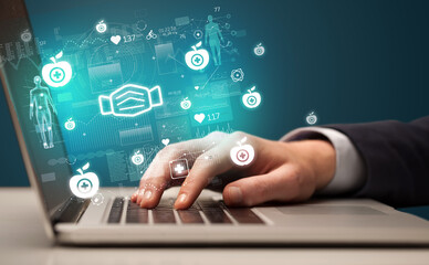 hand browsing on the internet for medical issues with mask icons coming out from the screen