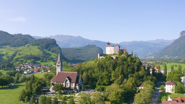 Burg Gutenberg, intact medieval castle and a church on a hilltop. Balzers, Liechtenstein
