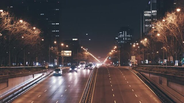 Busy road of Paseo de la Castellana, illuminated Madrid city night street view. Europe, capital of Spain