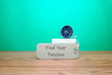 Magnetic compass with paper tag written " Find Your Passion " on the table