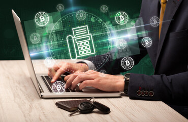 business hand working in stock market with fax icons coming out from laptop screen