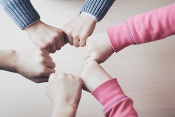 kids hands in circle together, friendship and peace concept